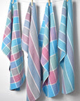 Spring inspired handwoven with organic cotton yarns hanging on a rope with clothespins