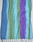 Close-up of the blue, green, and purple colors of the hand-painted cotton scarf