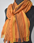 Fall inspired handwoven merino wool scarf styled on a mannequin. 