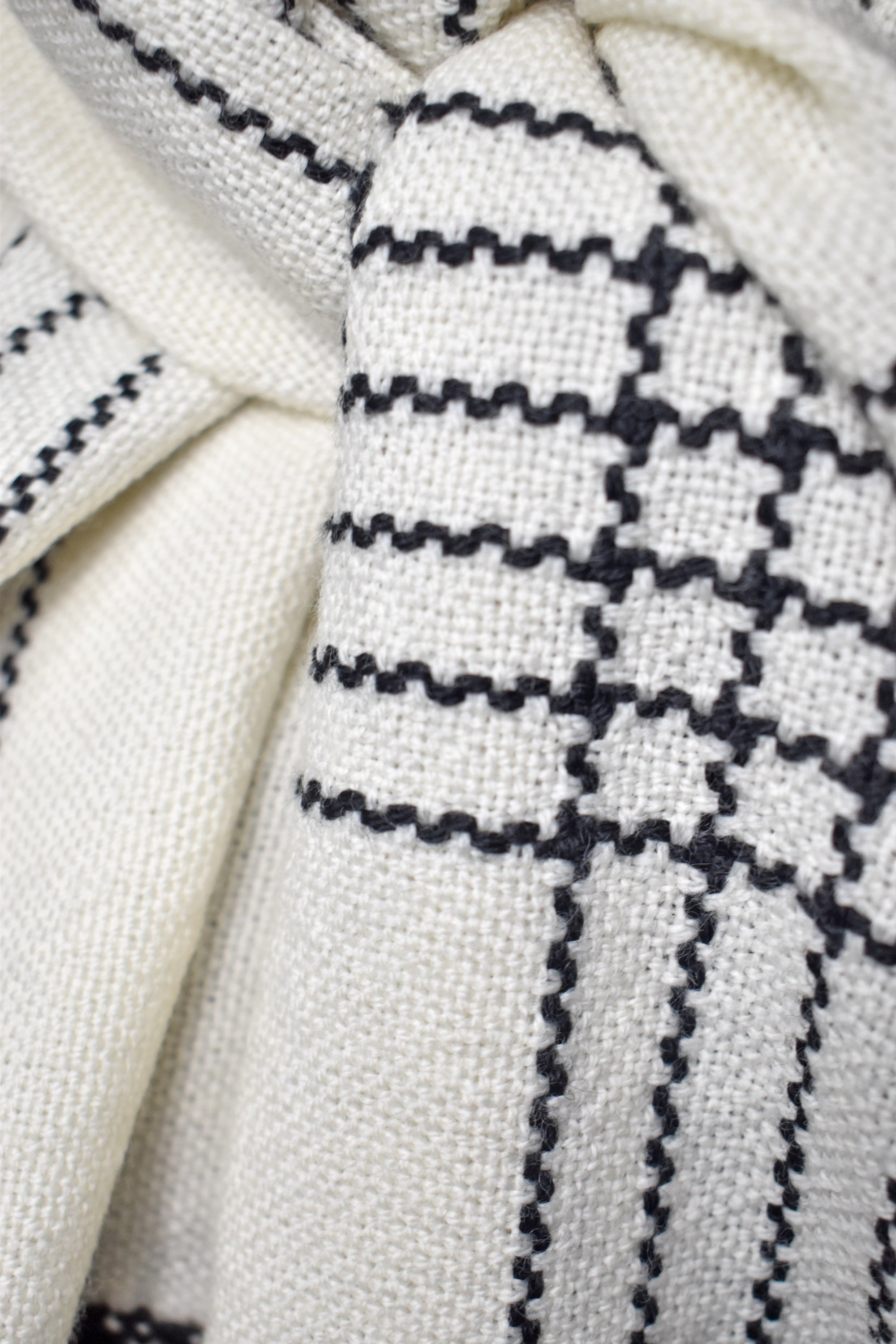 Close-up of white merino scarf on a model