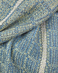 Close up view of the handwoven blue and green scarf. One side of the scarf is blue and the other is green.